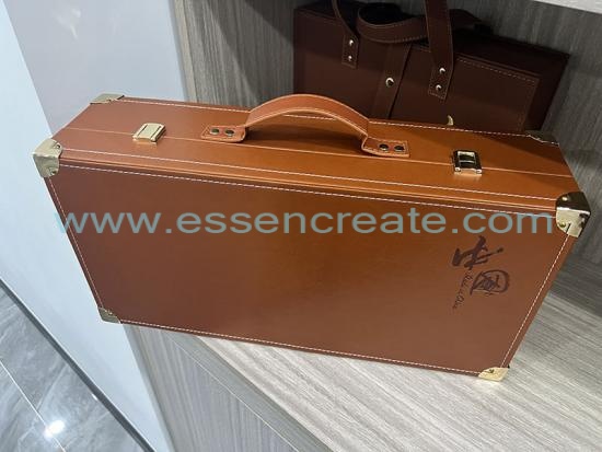 Leather brown suitcase with tea can packaging